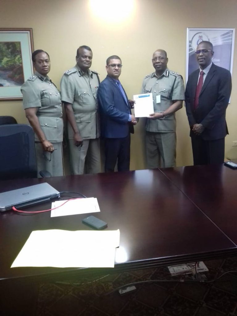 Promoted policeman Sgt Billy Ramsundar, third from left, receives his letter of promotion from acting CoP Stephen Williams, second from right. In photo are, from left, DCP Earla Christopher and DCP Deodat Dulalchan.  At right is DCP Harold Phillip. 