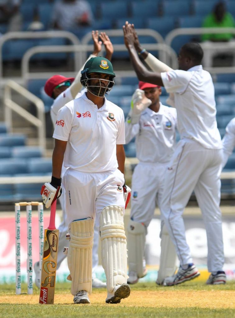 A disappointed Tamim Iqbal of Bangladesh walks off the field after being dismissed by Windies captain Jason Holder in the 2nd Test at Sabina Park, Jamaica. 