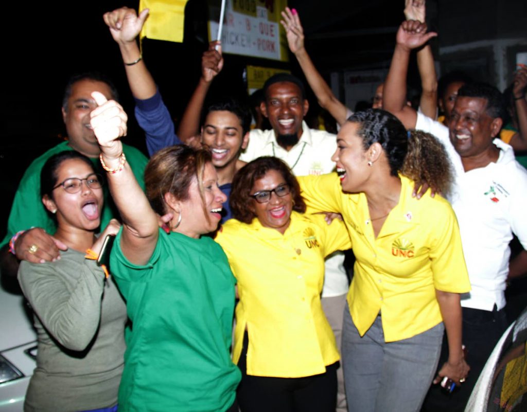 July 16, 2018. Victorious United National Congress (UNC) candidate in Barataria Sharon Maraj-Dharam (centre) is embraced by UNC Deputy Political Leader Khadijah Ameen (right) and other supporters at the UNC Third Avenue, Barataria campaign office.  