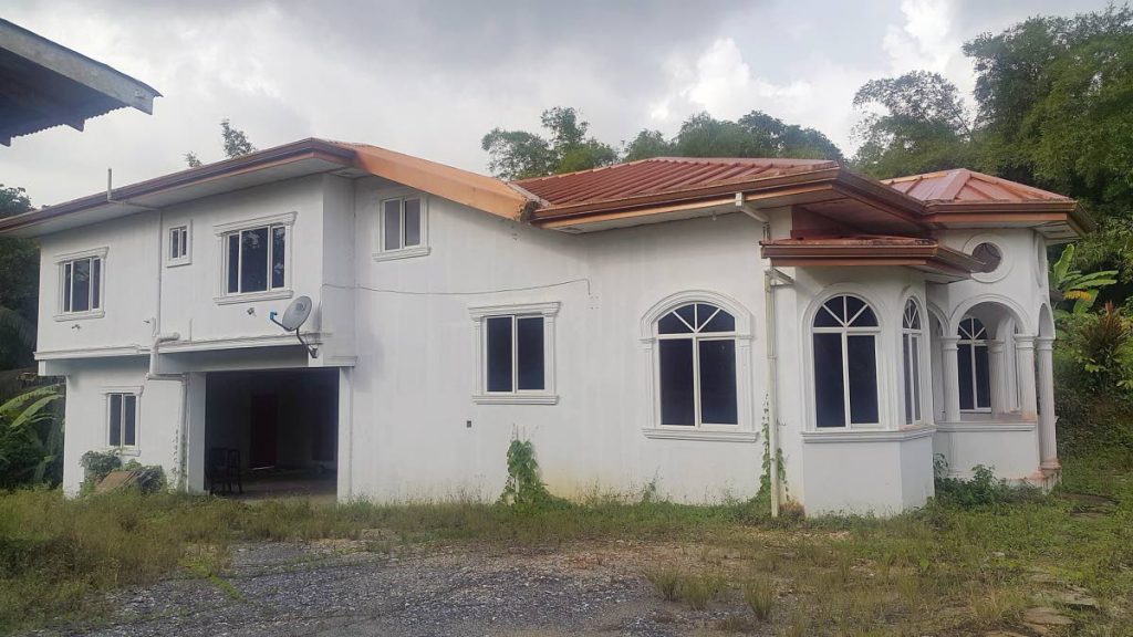 FOR SALE: This house in Sangre Grande was where mother of five Margaret Guevarra was shot dead in February. The house has been put up for sale by the Home Mortgage Bank. PHOTO BY ROGER JACOB