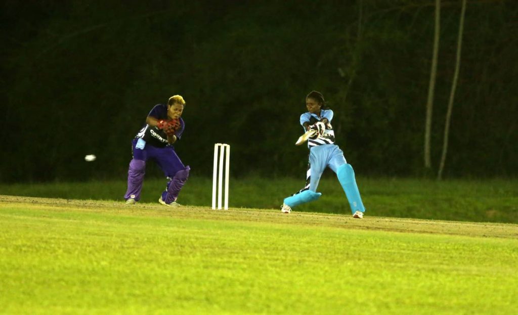 Felicia Walters of LCB Contractors Central Sharks plays a square cut as UDeCott North Starblazers wicketkeeper Natasha Mc Clean looks on during a Courts Women's T20 Grand Slam match at the National Cricket Centre, Balmain, Couva, Thursday.
