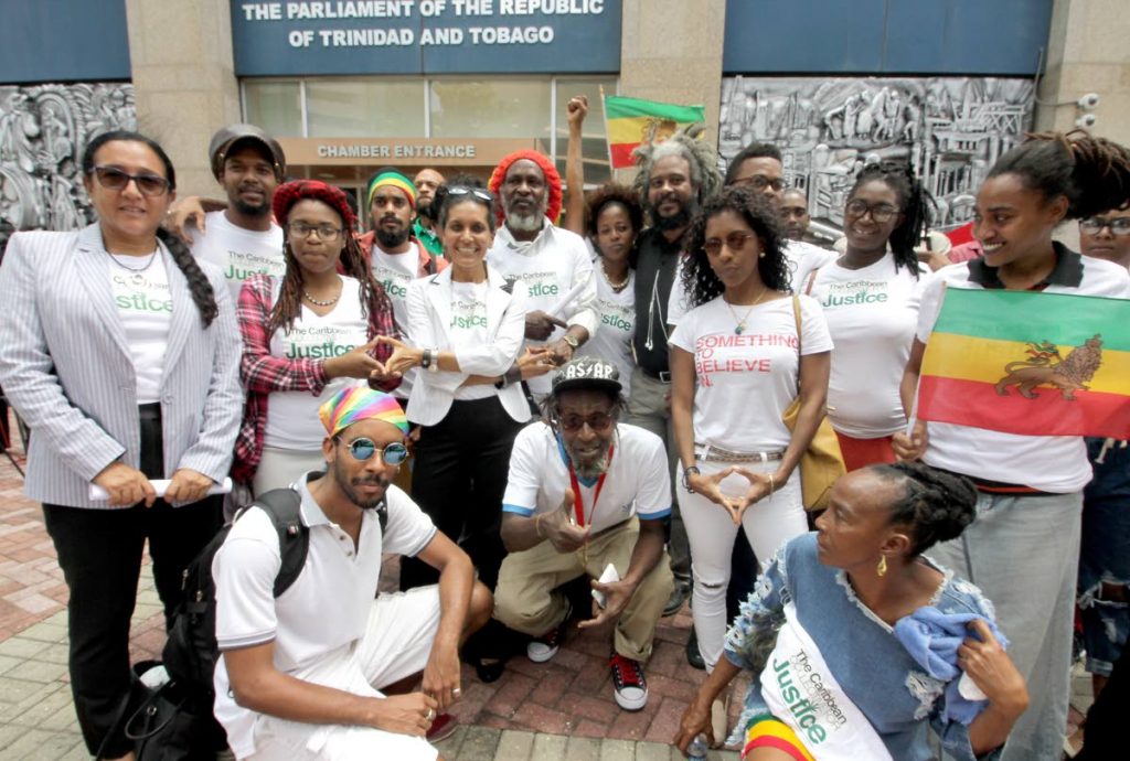 IRIE VIBES: The Caribbean Collective for Justice lead by activist Nazma Muller, outside the Parliament Chamber, Waterfront, PoS, yesterday.