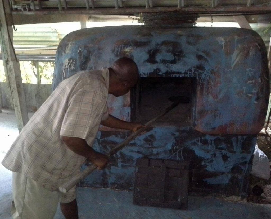 Richard Alfred, co-owner and manager of the Itsy Bitsy Folk Theatre and Museum in Mt Pleasant shows the dirt oven (still in use today) on display.  This oven was built in the 1960s and can hold 25 cakes and sweetbreads at a time.