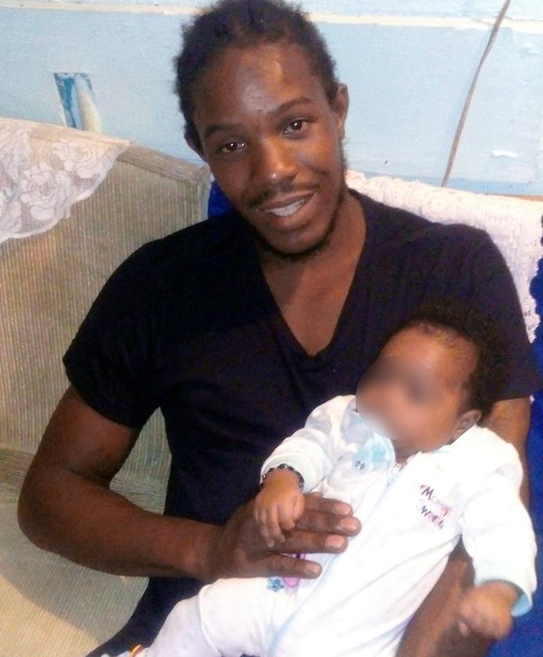 LIFE LOST, LIFE SAVED: Victor Walker holds his son in this photo posted to his Facebook account. Walker and another man were gunned down at a house in Tunapuna on Saturday moments after his son left him to go into another room to play with a kitten.