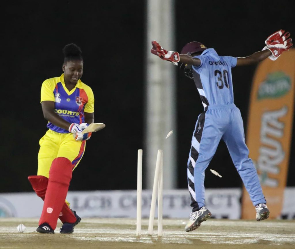 TECU Southern Titans opener Sheneta Grimmond is bowled for one by LCB Contractors Central Sharks' Felicia Walters (not pictured) as wicketkeeper Shemaine Campbelle celebrates in a Courts Women's T20 Grand Slam match on Sunday at the National Cricket Centre, Balmain, Couva.
