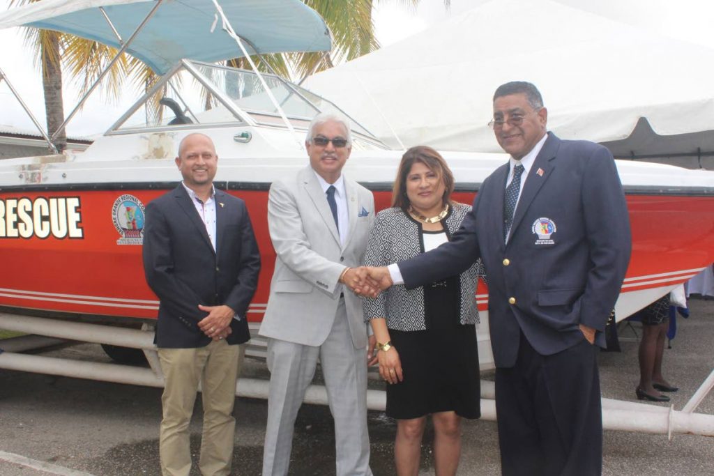 Ricardo Mohammed, (left to right) Minister of Health, Terrence Deyalsingh, Dianne Lakhan and Terry Rondon, chairman of the Sangre Grande Regional Corporation, stand before the water taxi.