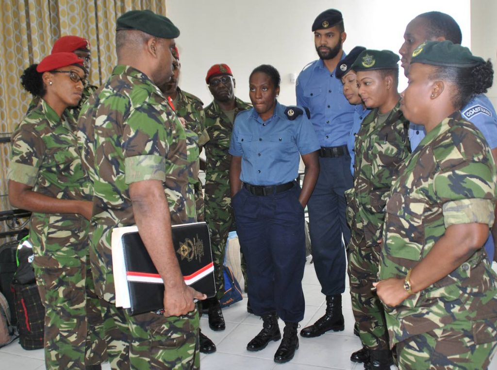 Col. Ronald Jeffrey (third from left), of the Defence Force, gives a pep talk during an orientation exercise to some of the supervisors who will oversee 34 teenaged males during their two-week camp at Teteron.