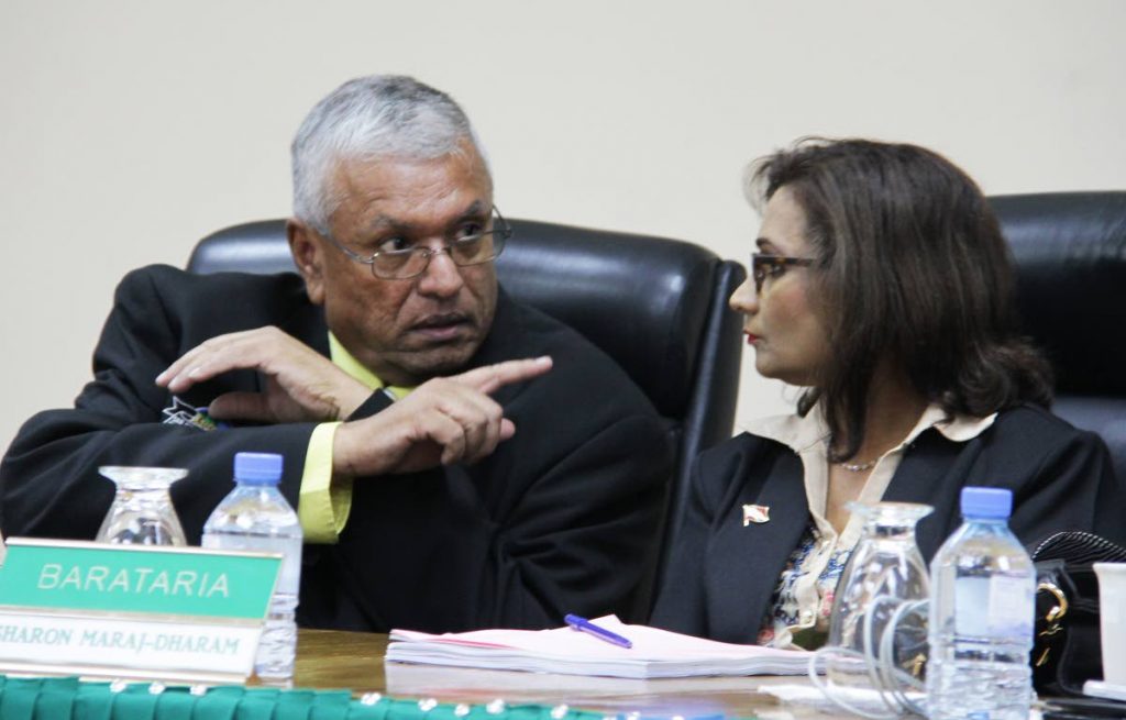 LISTEN: New Barataria councillor Sharon Maraj-Dharam is given a word of advice from San Juan Laventille regional corporation colleague Alderman Nazeemed Mohammed after she was sworn in yesterday.   PHOTO BY ROGER JACOB
