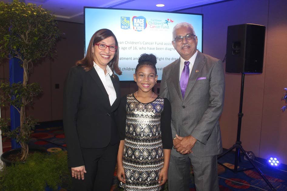 Destinee Britto, centre, takes a photograph with Minister of Health Terrence Deyalsingh, right, and managing director at RBC Gretchen Camacho-Mohammed at the launch of the 2018 RBC Race for the Kids at Hilton Hotel, yesterday.