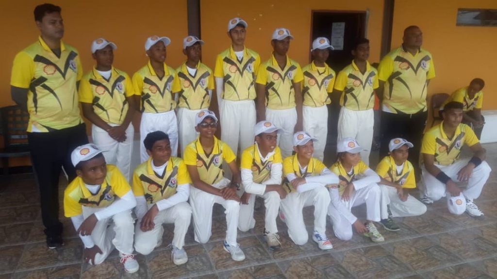 CHAMPS: Central Zone under-13 cricketers and coaching staff pose for a team photo. COURTESY TTCB