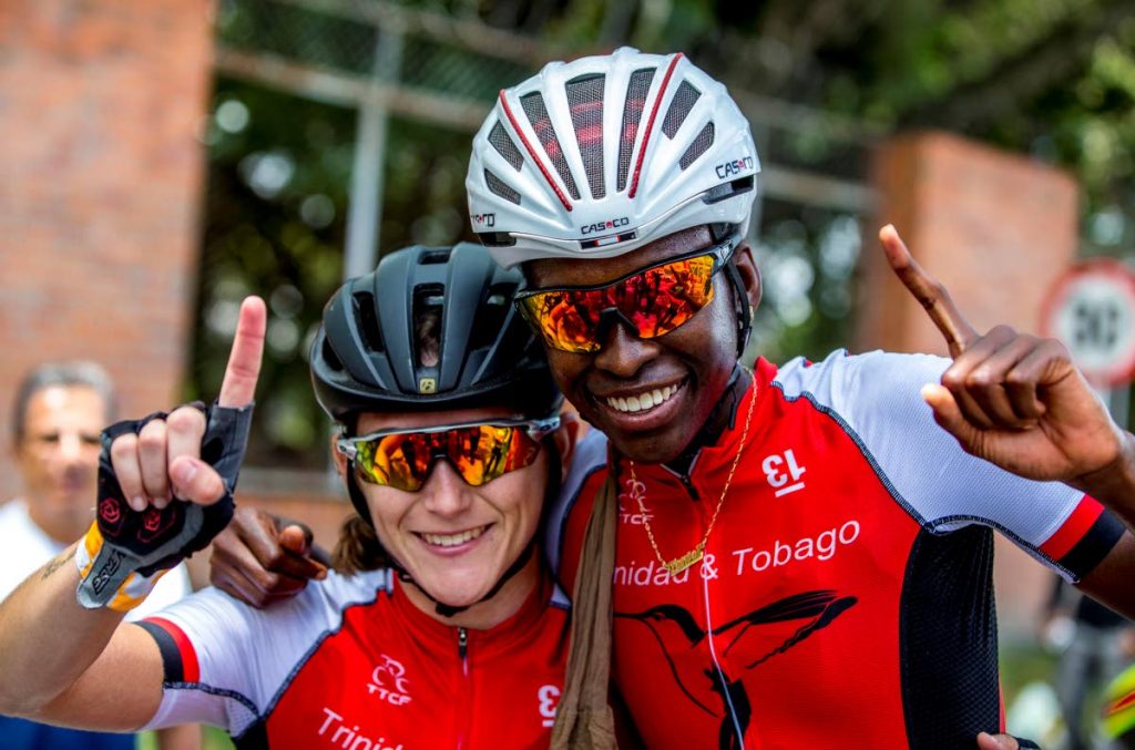 TT's Teneil Campbell, right, 2018 CAC Games road race champion, celebrates with compatriot Alexi Costa yesterday in Colombia. 