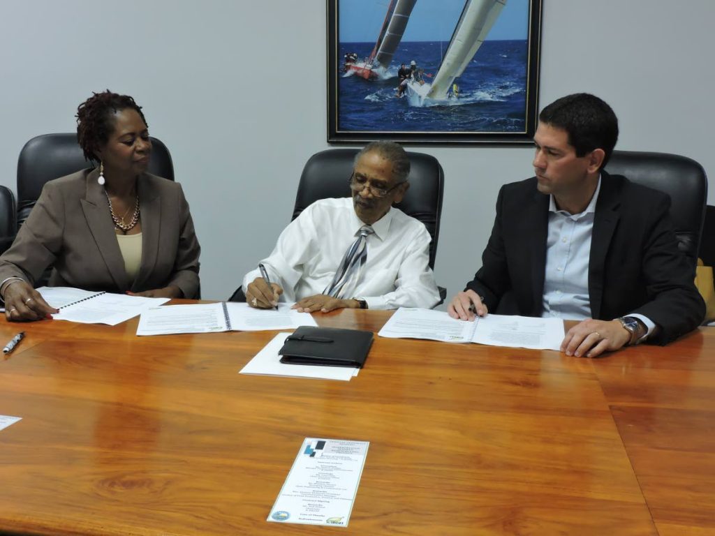 Neil Wilson, centre, Chairman, Eco-Industrial Development Company of Tobago (E-IDCOT), signs the contract on Thursday for the Scarborough Market Remodelling project in the presence of Lois Leslie, E-IDCOT’s Chief Executive Officer and contractor Matthew Devaux, Managing Director of Alpha Engineering & Construction Ltd.