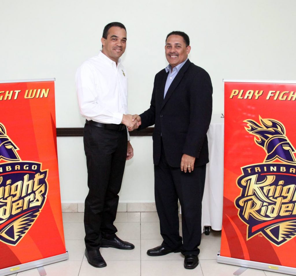 Trinbago Knight Riders general manager Paul Skinner, left, and Massy Technologies InfoCom CEO David Belgrave shake hands on a sponsorship agreement yesterday at President’s Box, Queen’s Park Oval, St. Clair.