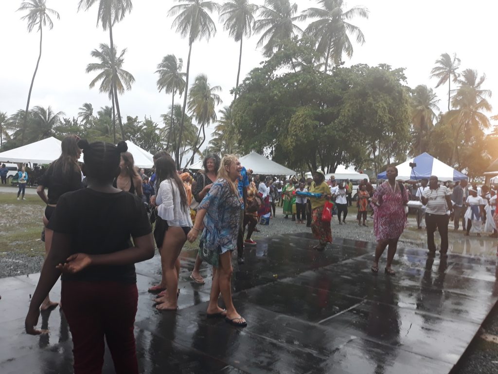 Patrons dance in the rain at the the Emancipation Day Gala and Drum Explosion on Wednesday at the Pigeon Point Heritage Park.   Photo  by Elizabeth Gonzales