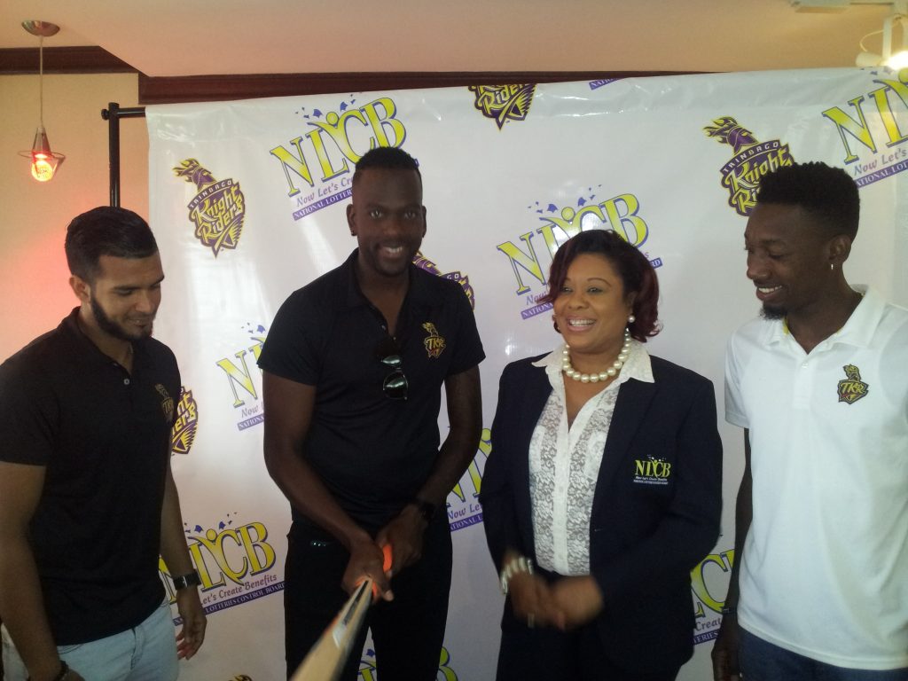 Marketing and public relations officer Susan Worrell, second from right, with Trinbago Knight Riders
cricketers Amir Jangoo, from left, Kevon Cooper and Khary Pierre.