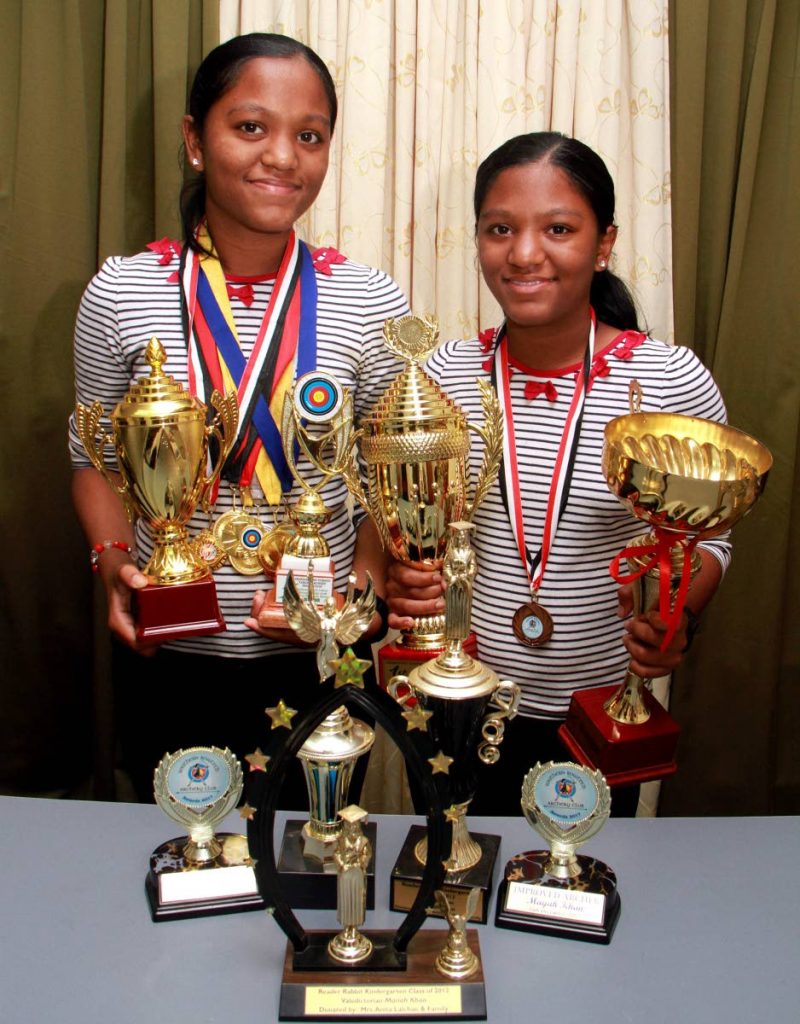 Top archers: Eleven-year-old twins Mariah, left, and Mayah Khan display their trophies and medals for archery
— a sport which they only began training for a year ago. 
PHOTO BY 
ANIL RAMPERSAD