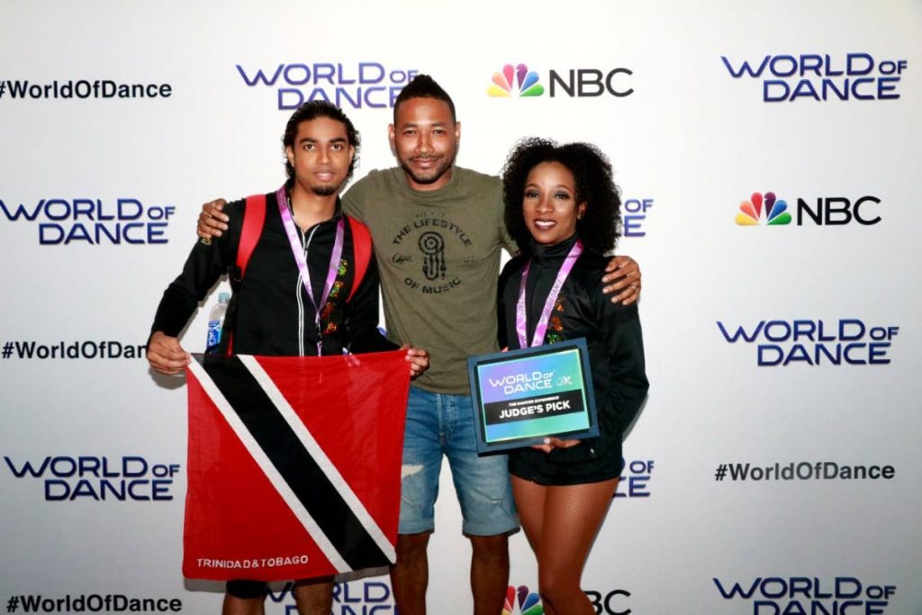 Trinidad and Tobago salsa dance duo Stefan Maynard left, and Karline Brathwaite at right holding their judge's pick certificate and local franchise holder Kyle Lequay centre 