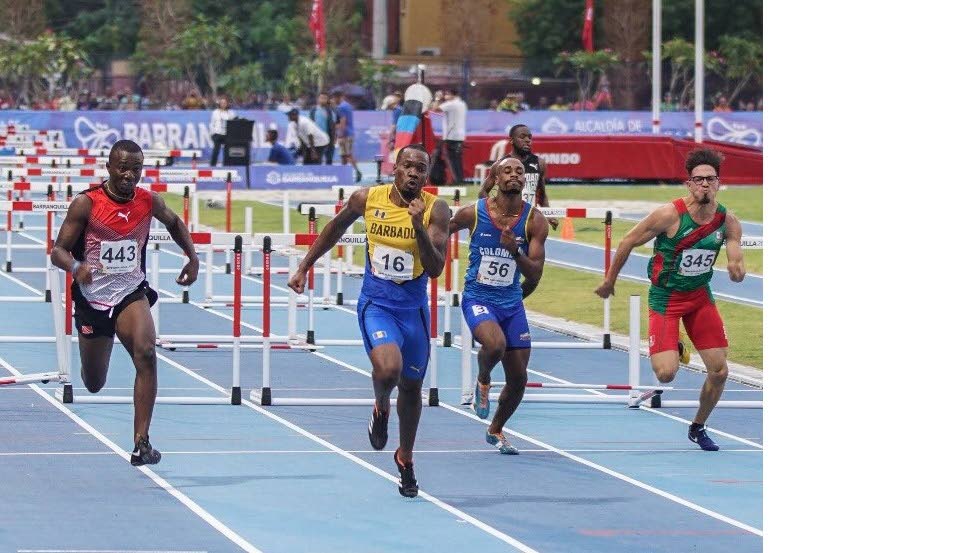 Bajan Shane Brathwaite, second from lleft, takes gold in the CAC 110m hurdles yesterday ahead of TT's Ruebin Walters, left, in Colombia. 