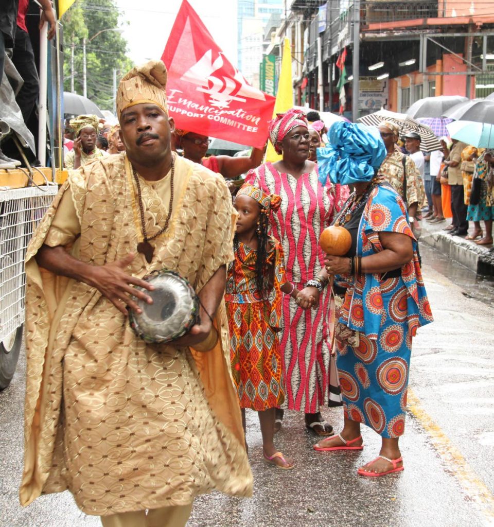 A man beats a drum during the Emancipation Day parade in Port of Spain last Wednesday. FILE PHOTO