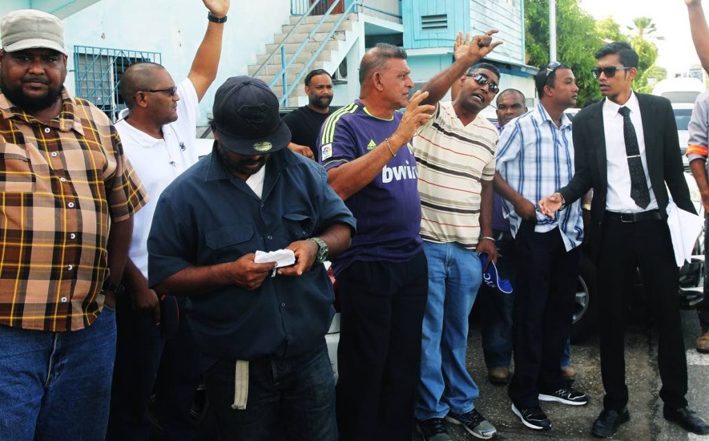 Workers of the Transport Division of the Chaguanas Borough Corporation staged an early morning protest on Friday, over unfair promotion practices, corruption and health and safety concerns. They are represented by attorney Richard Jaggasar, at right.