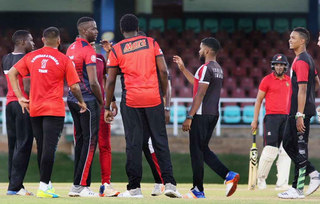 Kevon Cooper (third from left) is congratulated by his teammates after dismissing Trinbago Knight Riders’ Amir Jangoo (second from right) in Friday’s practice match.