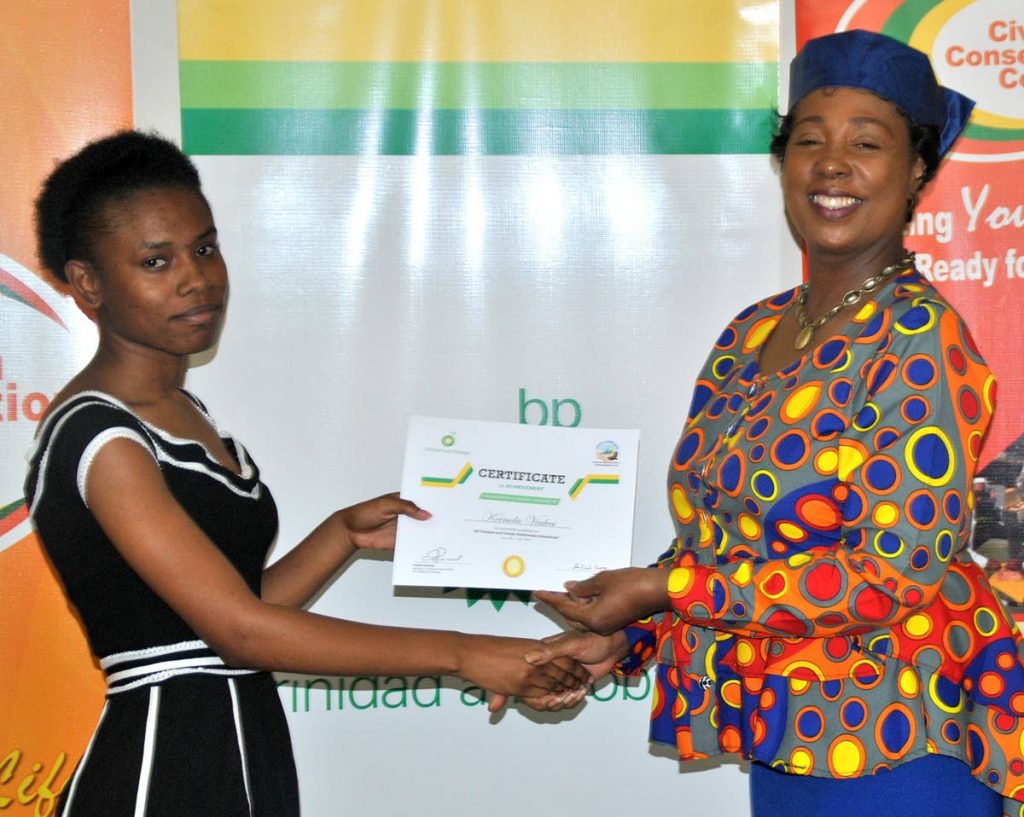 Keenola Vialva is presented with her Certificate of Achievement by Major Cheryl Richardson, CCC Programme Director, at the graduation ceremony of the CCC/BPTT Young Adult Math Experience.

