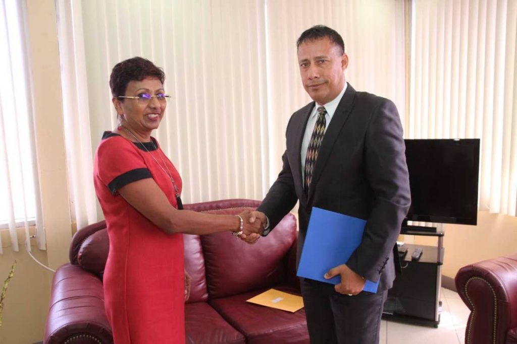 Police Service Commission chairman Bliss Seepersad congratulates Commissioner of Police Gary Griffith after presenting him with his appointment letter on August 3. FILE PHOTO