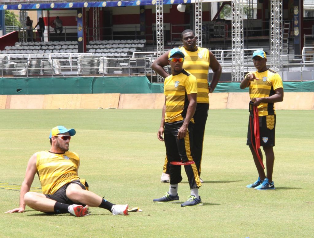 St Lucia Stars players (from left) Mitchell McClenaghan, Kaveem Hodge and Rahkeem Cornwall train yesterday alongside a member of the technical staff at the Queen's Park Oval, St Clair, yesterday. 