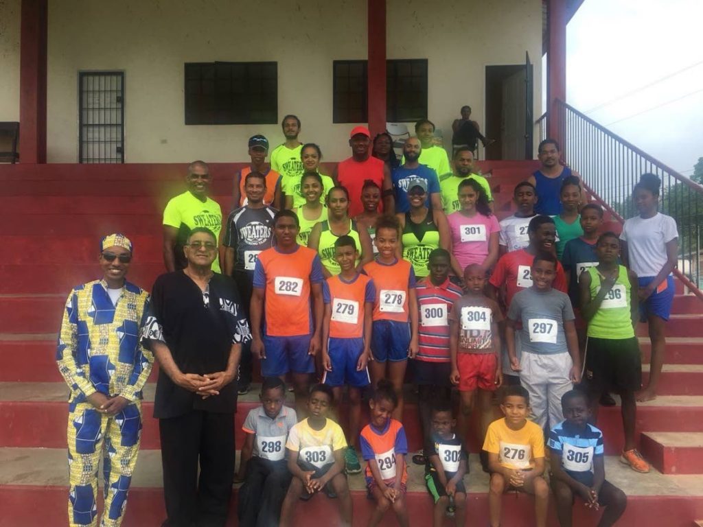 Councillor Paul Mongolas, left, and chairman Martin Terry Rondon, second from left, pose with participants before the start of the 'D Grande Classic: Back to Recreation Ground' marathon last week.