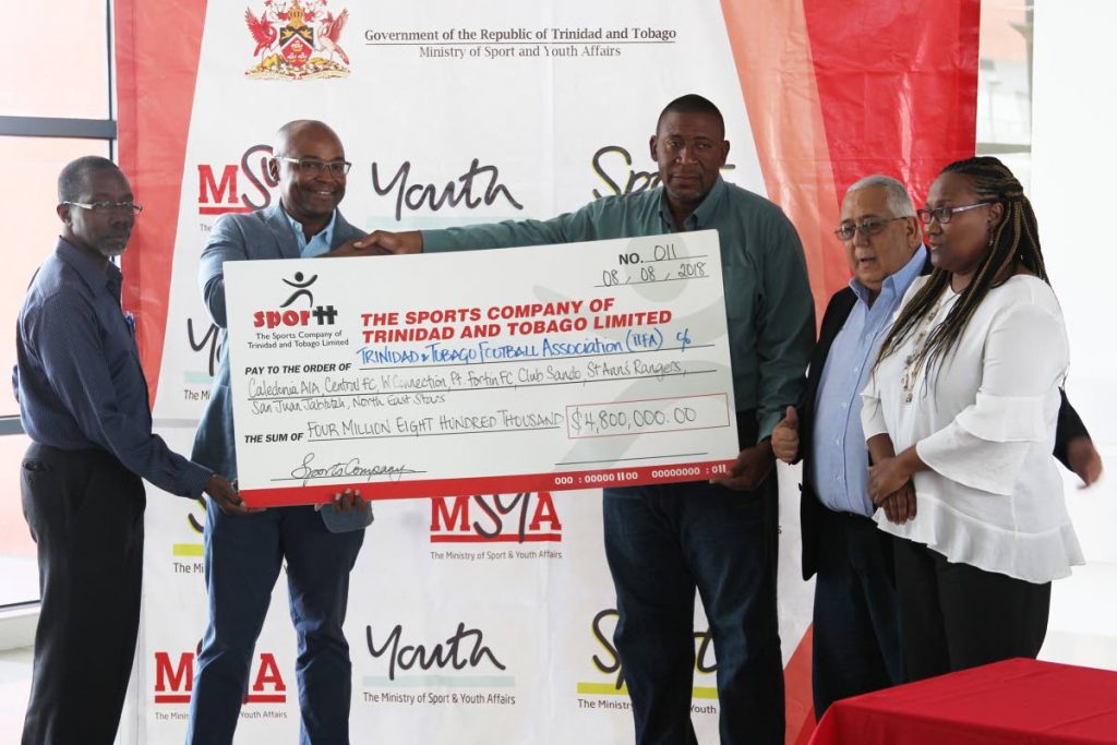 TTFA president David John-Williams (third from right) shakes hands with SporTT director Hayden Mitchell, while Patrice Charles, director of physical education at the Ministry of Sport and 
Youth Affairs (left), Pro League chairman Richard Fakoory (second from right) and 
Pro League CEO Julia Baptiste look on.