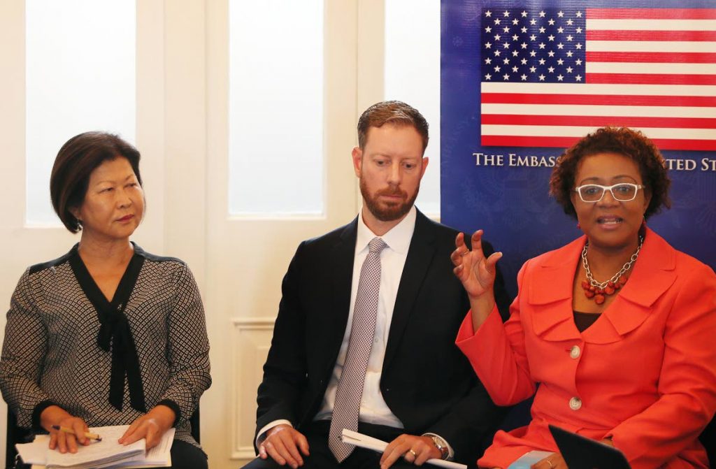 Panel discussion on migrant smuggling and human trafficking in the Caribbean held at the Writers Centre. At right Alana Wheeler of the Counter Trafficking Unit speaks as political officer at the US Embassy Kyle Fonay and Mary Moonan of Childline looks on.