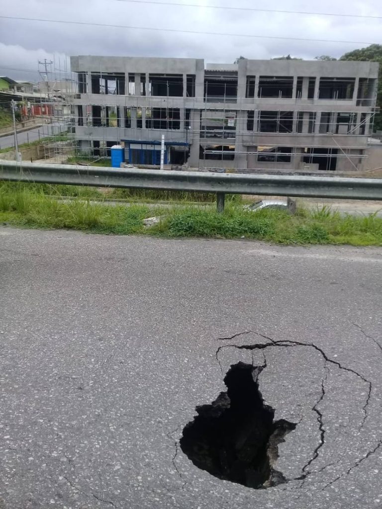 DANGER: The sinkhole which opened up yesterday along 
the southbound lane of the Solomon Hochoy Highway after 
the Freeport flyover.