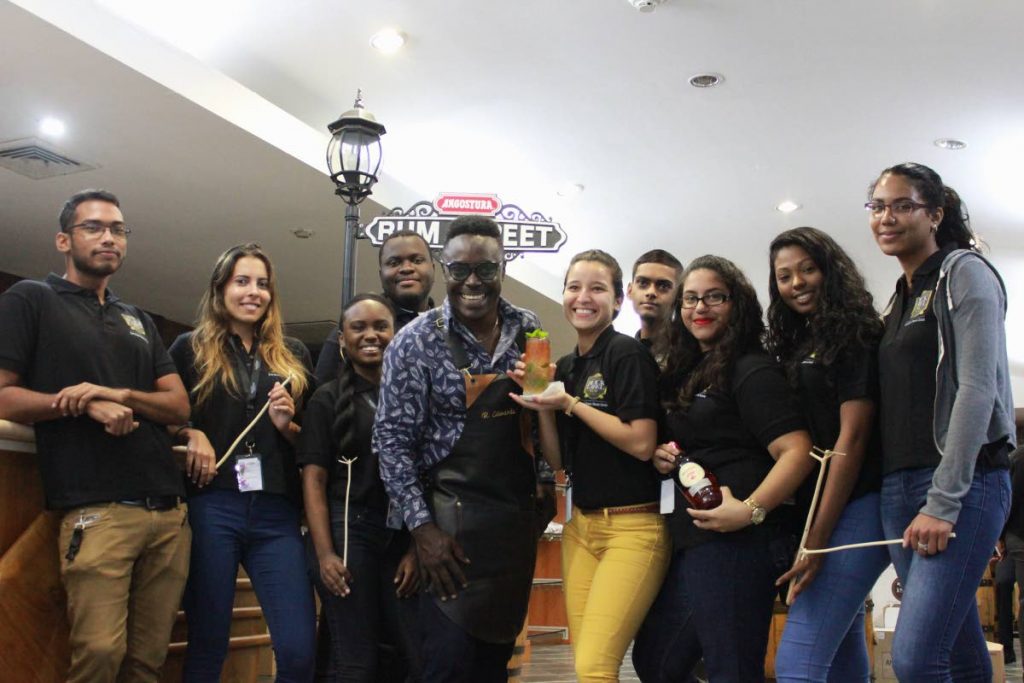 The House of Angostura’s July-August Holiday university interns enjoy a tour of the company with Angostura Chief Mixologist Raymond Edwards. PHOTO COURTESY ANGOSTURA