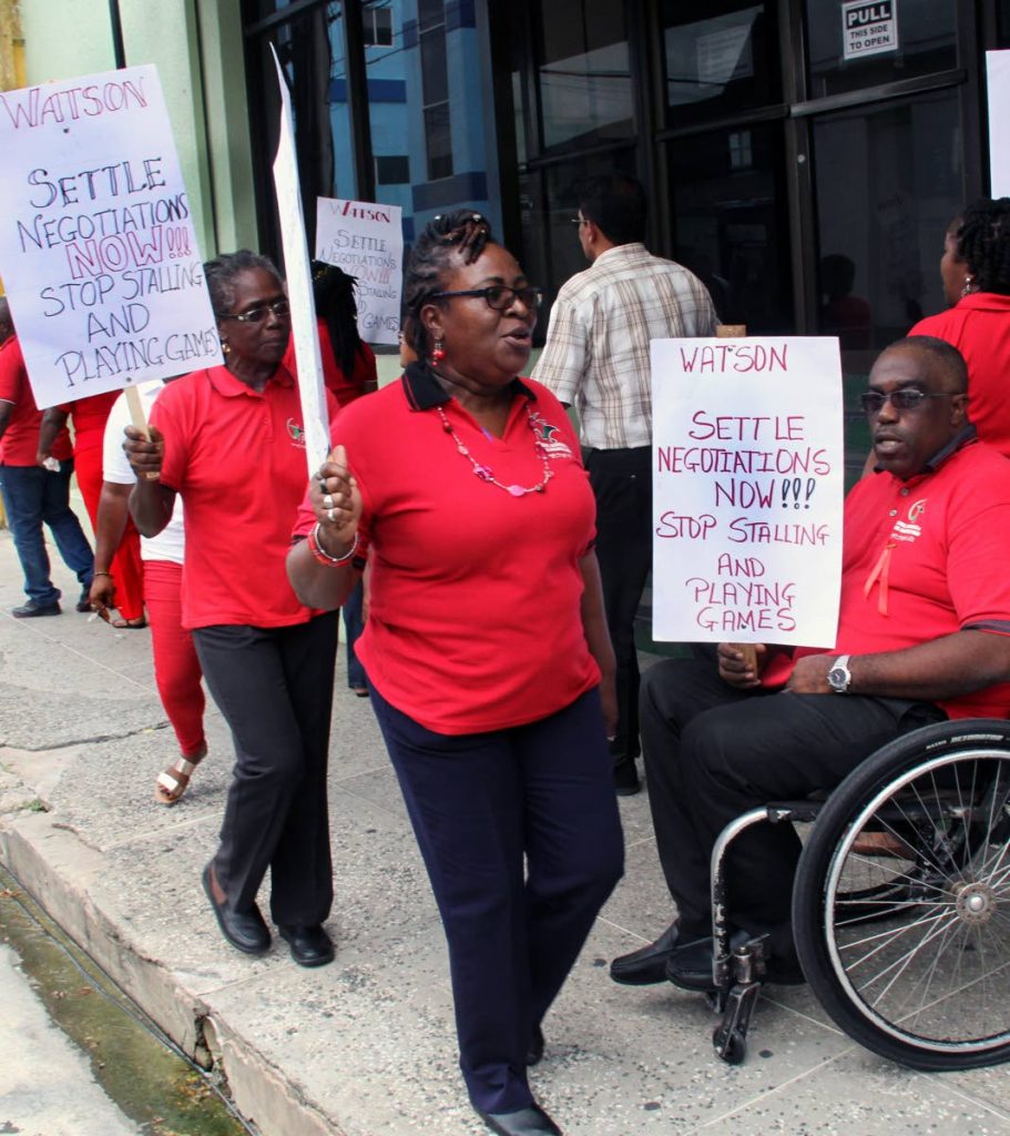UNION VS UNION: PSA workers represented by Banking, Insurance and General Workers Union protest outside their association’s head office on Abercromby Street, Port of Spain,  yesterday. PHOTO SUREASH CHOLAI