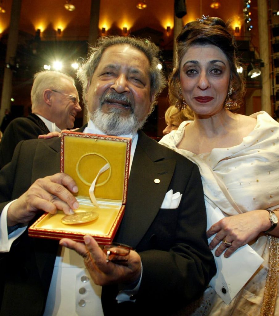 Nobel literature laureate Sir V S Naipaul, with his wife Nadira at his side, displays his medal after receiving it from the Swedish king at the Concert Hall in Stockholm, December 10, 2001.