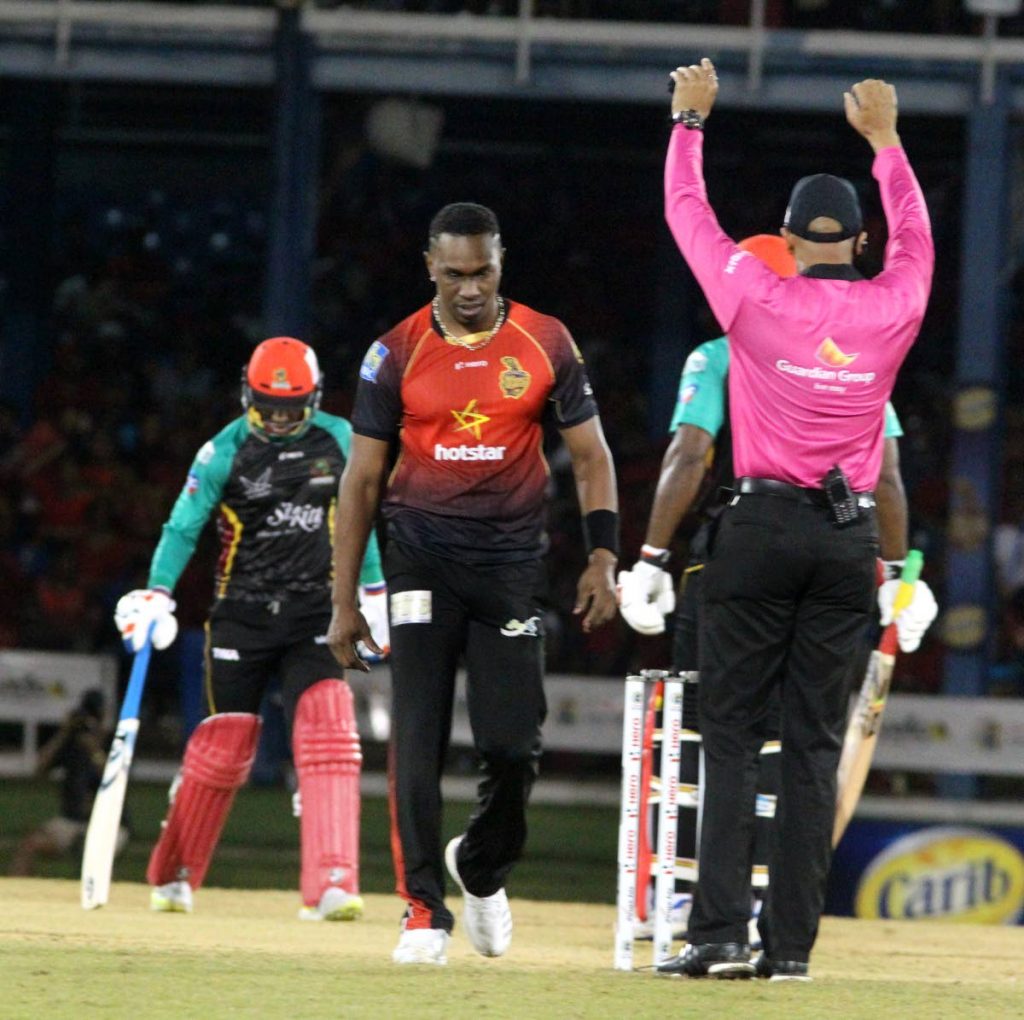 Trinbago Knight Riders captain Dwayne Bravo walks back to his marker a disconsolate figure after being hit for six by St Kitts and Nevis Patriots' Devon Thomas on Saturday at the Queen's Park Oval, Port of Spain. 