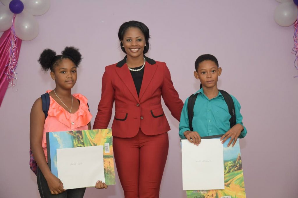 West Indies cricketer and Atlantic sports ambassador Merissa Aguilleira, centre, with Tyrese Bernard, right, and Akeelah Nelson, the top male and female SEA students of the Morgua district