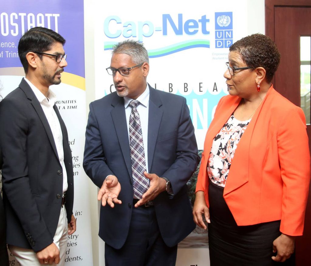 Agriculture Minister Clarence Rambharat (centre) speaks with Dr Ronald Roopnarine - network manager, Caribbean Waterfront Cap - Net UNDP and Dr Gillian Paul, president of COSTAATT at the opening ceremony of the Integrated Urban Flood Risk Mitigation and Management workshop.   
 PHOTO BY VASHTI SINGH