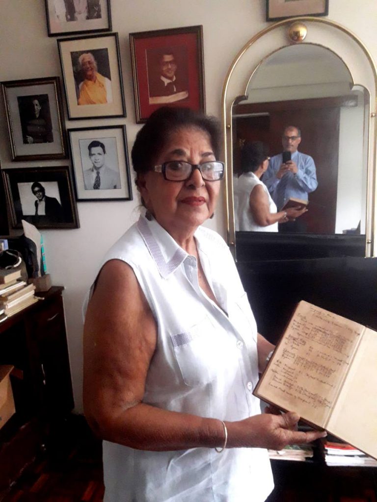 NO INFO: Savi Akal, sister of 
Sir Vidia Naipaul shows off 
a report book from Nailpaul’s school days at Queens Royal 
College.