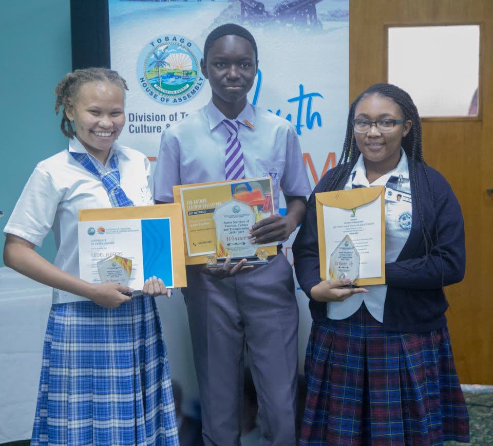 Junior Secretary of Tourism Jahmone Madden, centre, is flanked by with first runner-up Tenomrette Pitcher, right, and second runner-up, Ledel Jeffers, after winning the Junior Secretary Competition on July 3 Tourism Youth Forum hosted by the Division of Tourism at the Shaw Park Cultural Complex. THA Photo