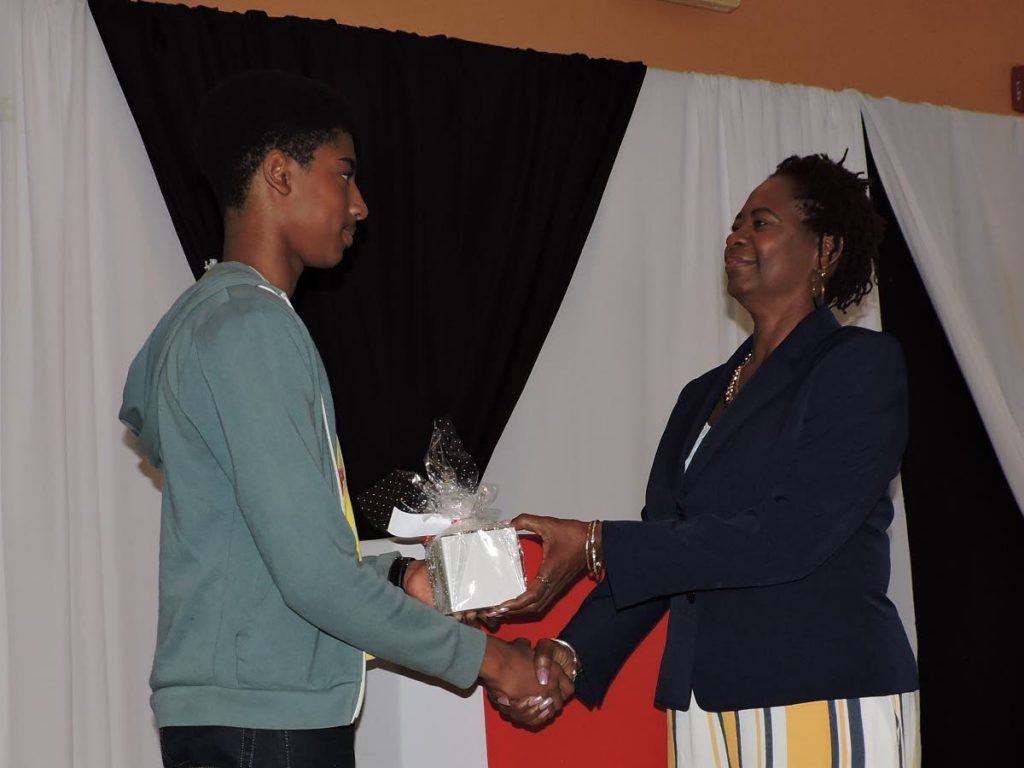 Lois Leslie, right, Chief Executive Officer of E-iDCOT’s is presented with a token of appreciation from a graduate at Friday’s graduation exercise for 27 participants of the Tobago Young Innovators Camp at the Tobago Hotel and Tourism Institute (THTI) Conference Room in Mt St George.