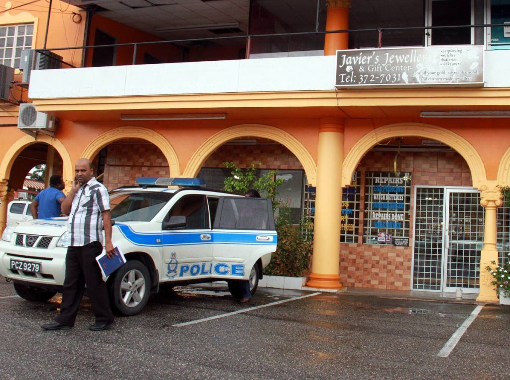 A police vehicle parked in front of Javier’s Jewellery shop at the GN Shopping Centre in Penal after the owner Roger Pilgrim was shot during a robbery at the store. PHOTO BY ANIL RAMPERSAD
