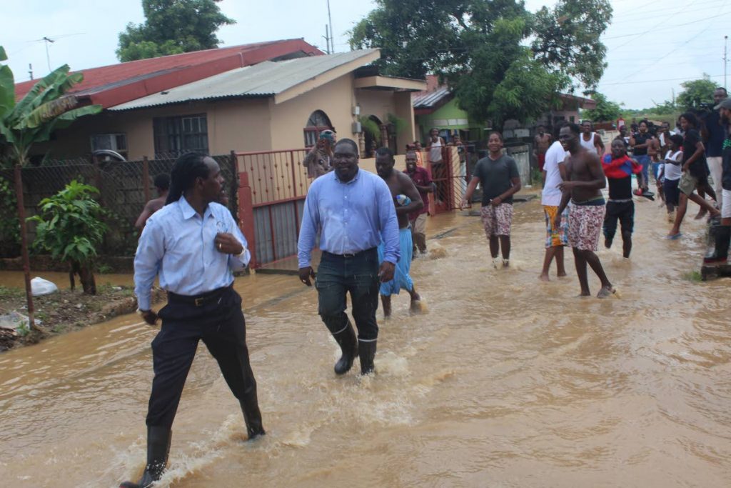 August 15, 2018: RUN, FITZ, RUN: Acting  Attorney General Fitzgerald Hinds runs away from Beetham residents after getting a dirty water bath yesterday. PHOTO BY ENRIQUE ASSOON