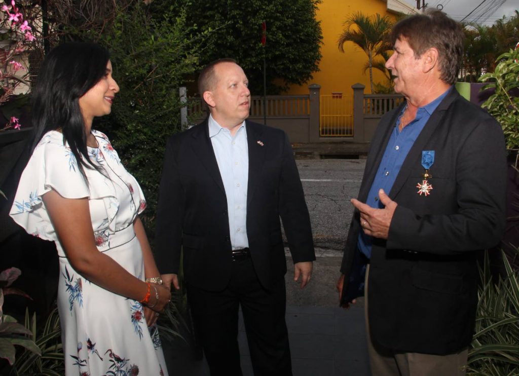 Honorary consul for Poland, David Lewis, right, and his wife, Reisha Ramnarine-Lewis, speak with US Embassy charge d’affaires John McIntyre, centre, during a celebration of 20 years of diplomatic relations between TT and Poland at More Vino Wine Bar, Woodbrook