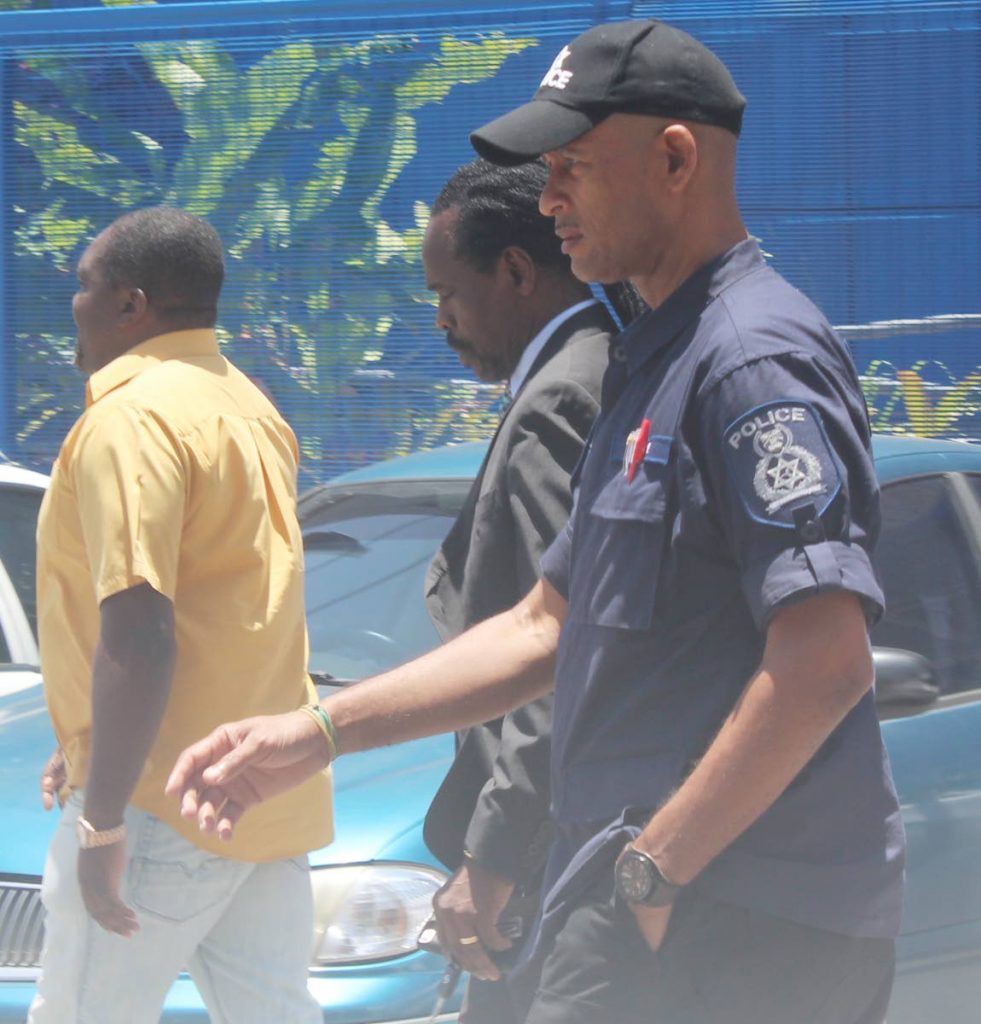 STATION REPORT: Fitzgerald Hinds  leaving the Besson Street police station yesterday after making a report .PHOTO BY ENRIQUE ASSOON