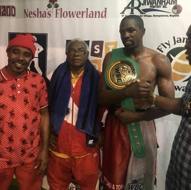 TT boxer Sheldon Lawrence, right, Lawrence's manager Buxo Potts, centre, and coach Alric Johnson.