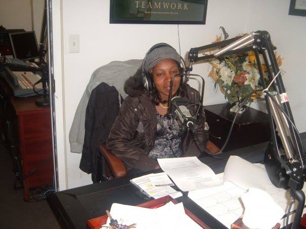 Carletta Figaro hosting a radio programme  while abroad encouraging long-time immigrants to assist and support new ones. The programme was called Footprints in the Sand.