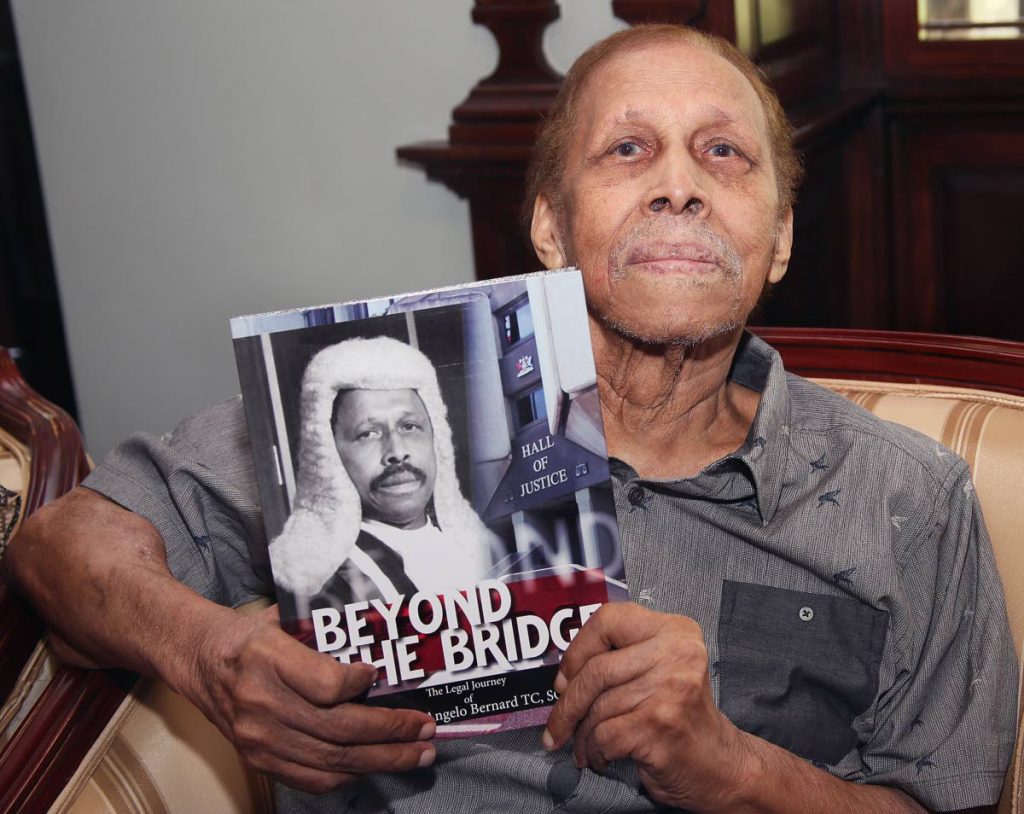 Retired Justice Clinton Bernard with a copy of his new book 'Beyond the Bridge' at the book launch held at Castle Killarney,Queens Park  West
PHOTO BY AZLAN MOHAMMED