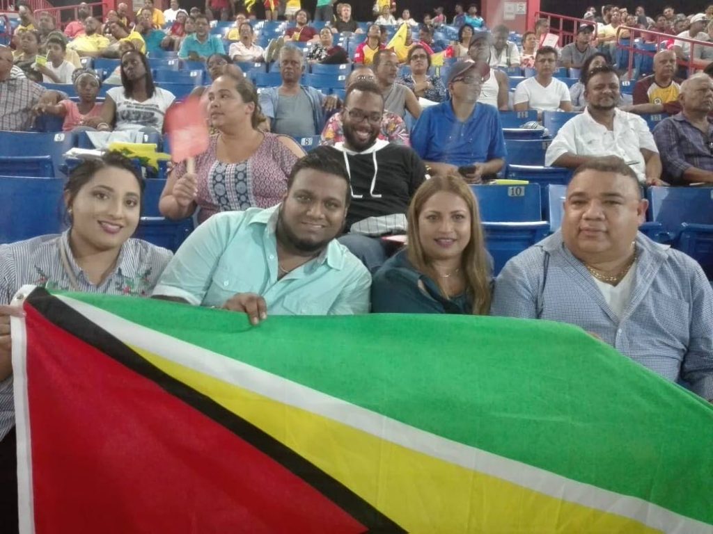PAUL DaSilva,right, former president of the Nassau New York Cricket Assocition and members of his family enjoy a night of cricket at the Central Broward Regional Pak and Stadium, Ft Lauderdale, on Saturday, as the Guyana Warrior took on the Jamaican Tallawahs.