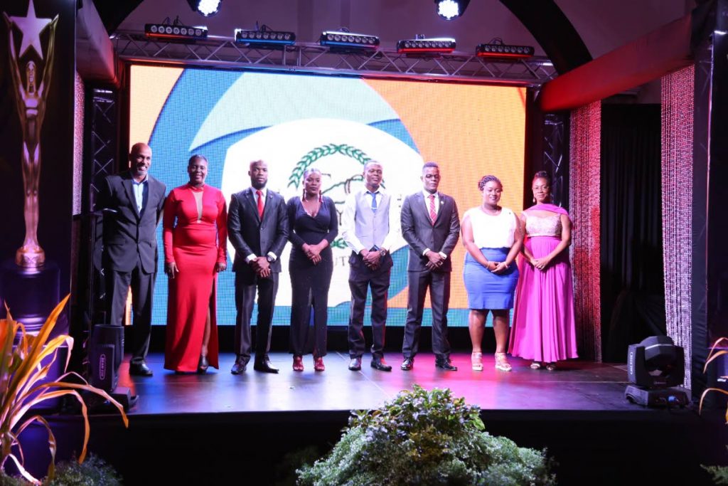 Youth Affairs Secretary Jomo Pitt, left, stands with the newly inducted Executive of the Tobago Youth Council at the Tobago House of Assembly’s Youth Awards on October 12, 2017. From left are President Latoyaa Roberts-Thomas; Vice President, Kern Johnson; Secretary Rheanne Moore; Treasurer Collin Edwards; Public Relations Officer Kevon Mc Kenna; Trustee Arlene Brebnor. At right is Administrator of the Division, Wendy Guy-Hernandez. The event took place at the Magdalena Grand Beach and Golf Resort.